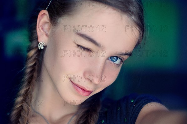 Caucasian teenage girl winking