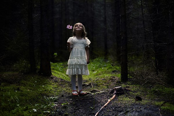 Caucasian girl standing in forest