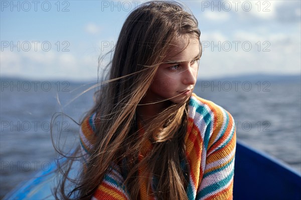 Caucasian teenage girl in canoe on lake