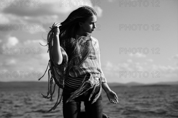 Caucasian girl standing over lake