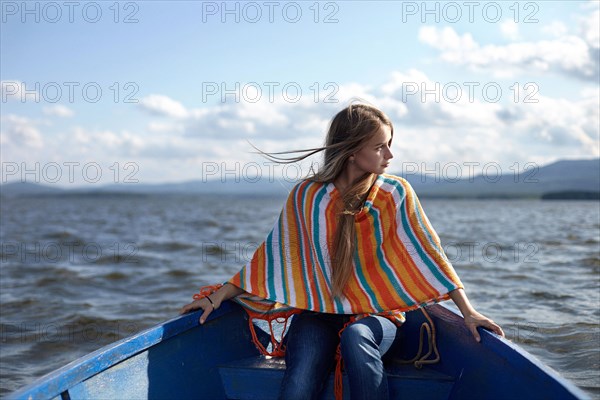 Caucasian teenage girl in canoe on lake
