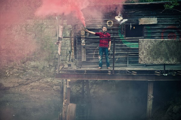 Caucasian man spraying pigment powder