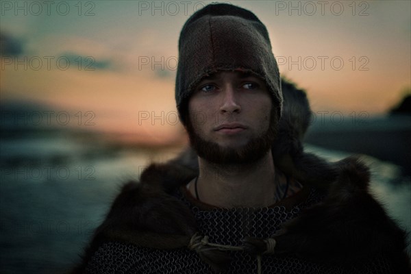 Caucasian man wearing hat and cape