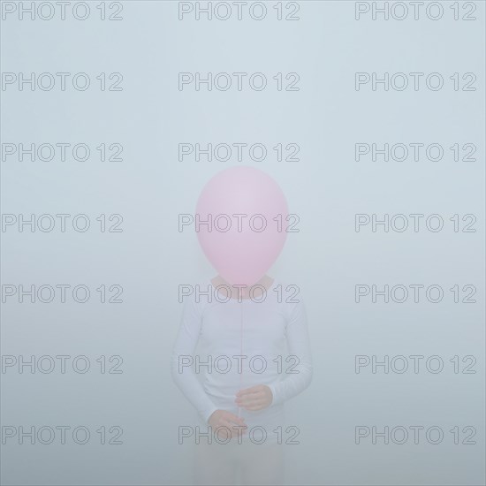 Caucasian teenage girl holding balloon