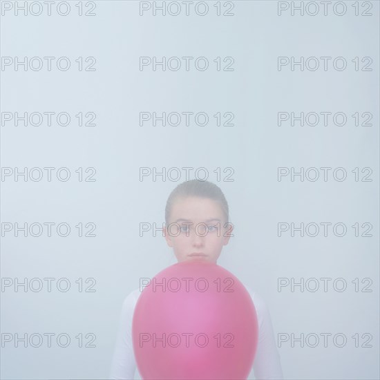 Caucasian teenage girl holding balloon