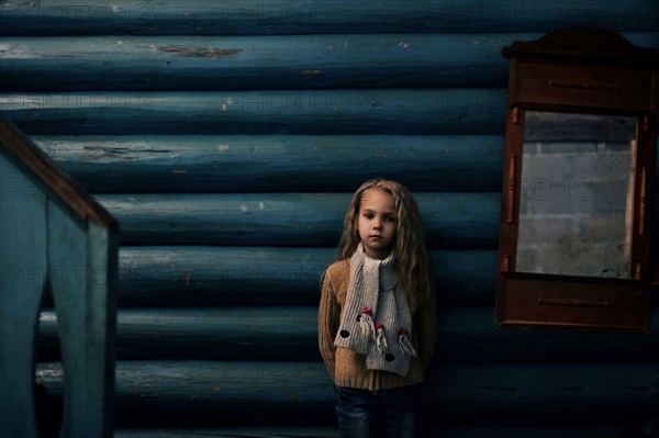 Caucasian girl standing near log cabin