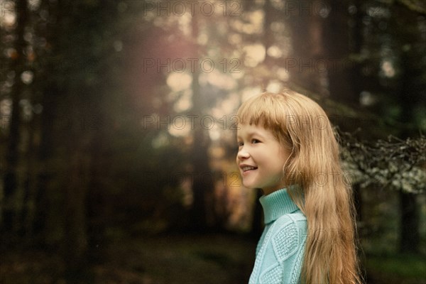 Caucasian girl walking in forest