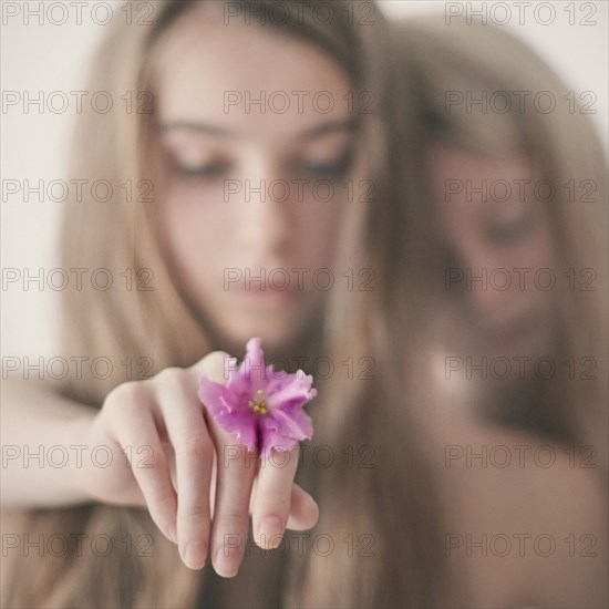 Caucasian teenage girl holding flower