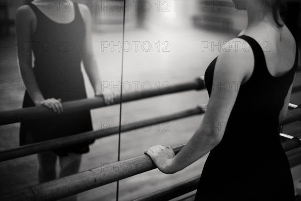 Caucasian ballerina standing at barre