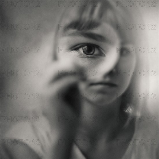 Caucasian girl looking through magnifying glass