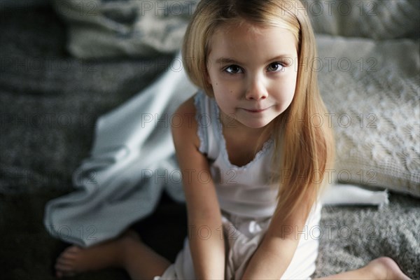 Caucasian girl smiling on bed