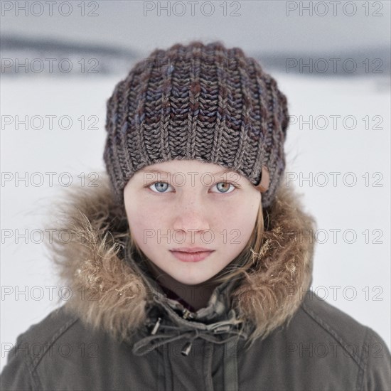 Caucasian teenage girl wearing beanie hat in snow