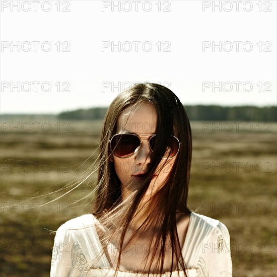 Caucasian woman standing in rural field