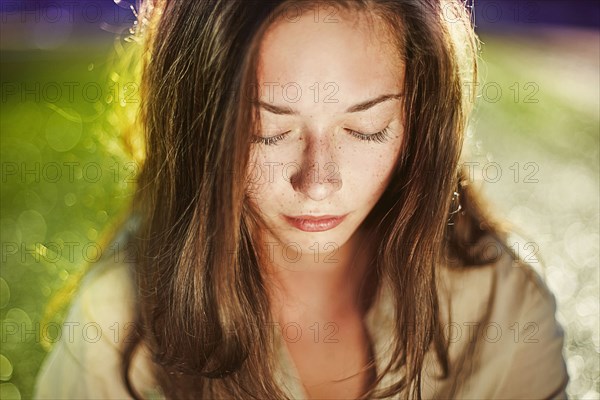 Caucasian teenage girl with eyes closed