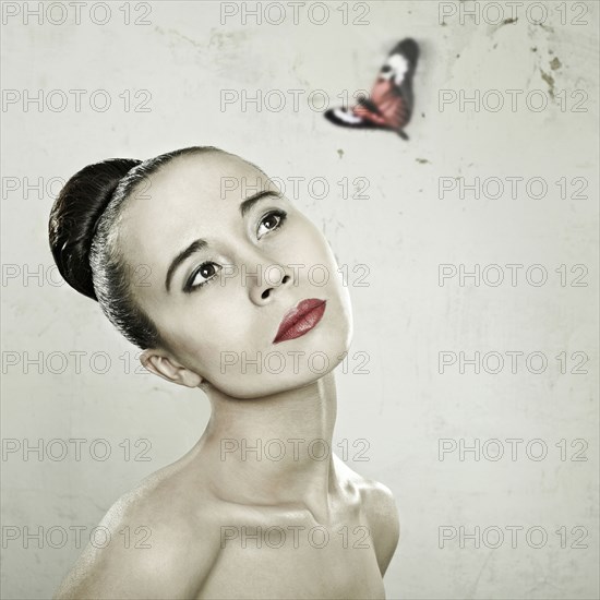 Caucasian woman admiring butterfly