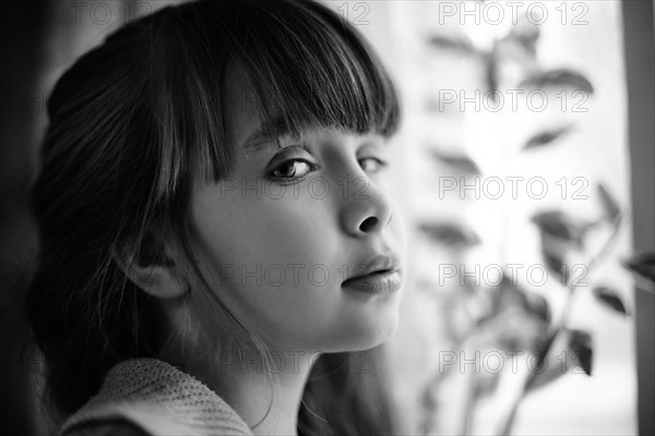 Profile of Caucasian girl with cynical expression