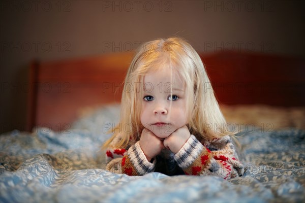 Caucasian girl laying on bed