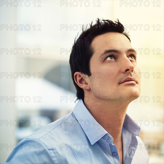 Caucasian businessman looking up