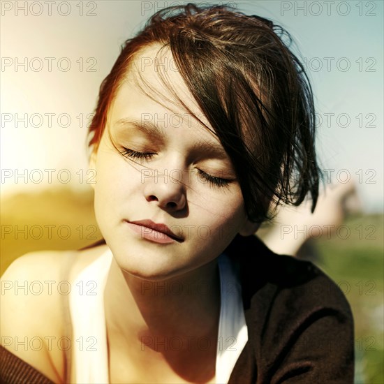 Close up of Caucasian teenage girl with eyes closed