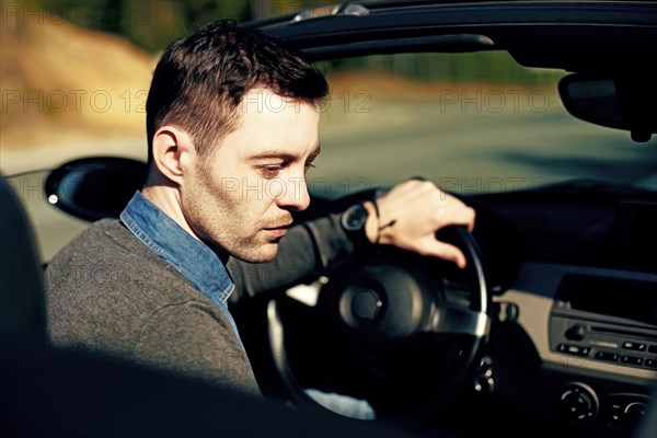 Caucasian man driving convertible
