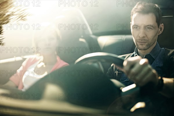 Caucasian father and daughter driving in car