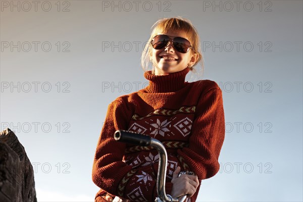 Caucasian girl smiling on bicycle