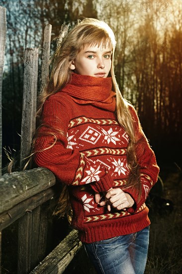 Caucasian girl leaning on fence