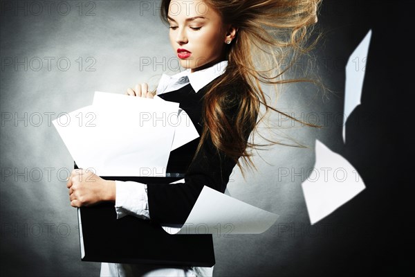 Caucasian teenage girl with windblown papers