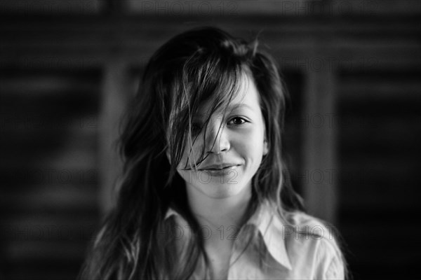 Caucasian teenage girl smiling indoors