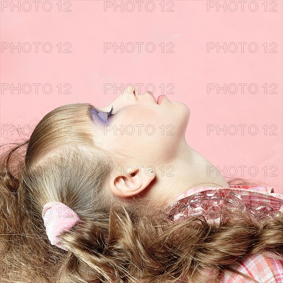 Profile of Caucasian girl wearing makeup