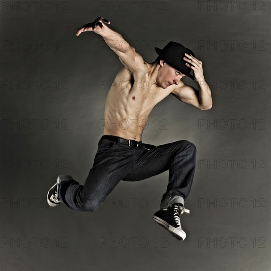 Caucasian dancer jumping for joy