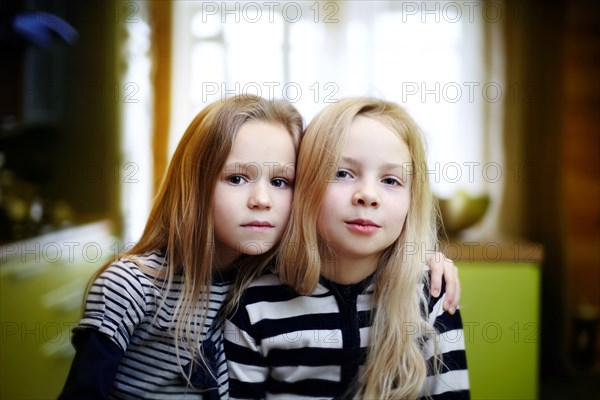 Caucasian girls sitting indoors