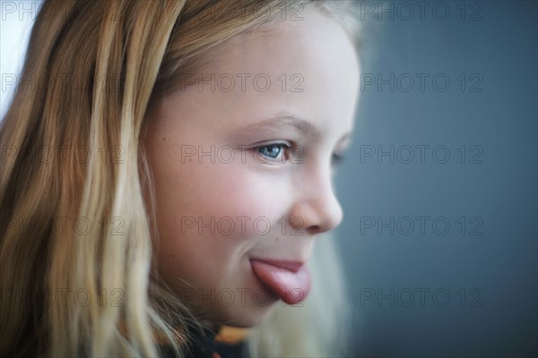 Caucasian girl sticking out tongue