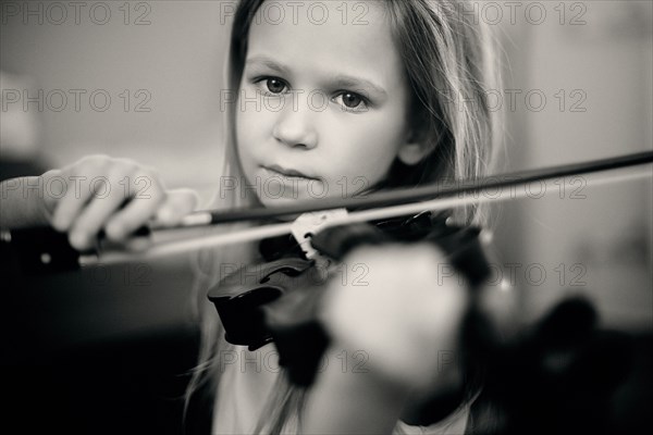 Caucasian girl playing violin