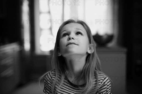 Caucasian girl looking up