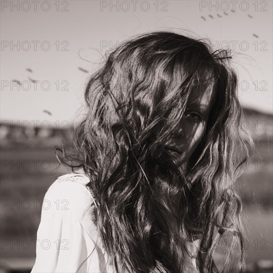 Caucasian woman standing in rural field