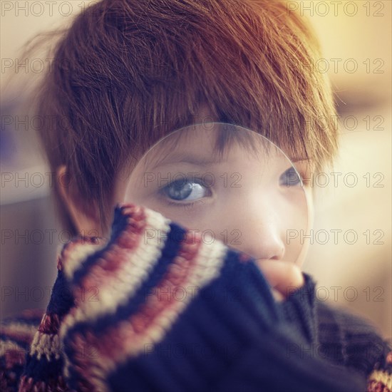 Caucasian girl looking through magnifying glass