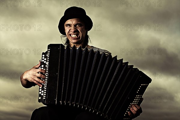 Caucasian man playing accordion outdoors