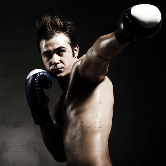 Low angle view of Caucasian boxer punching