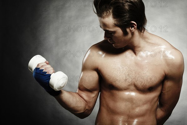 Caucasian athlete lifting weights