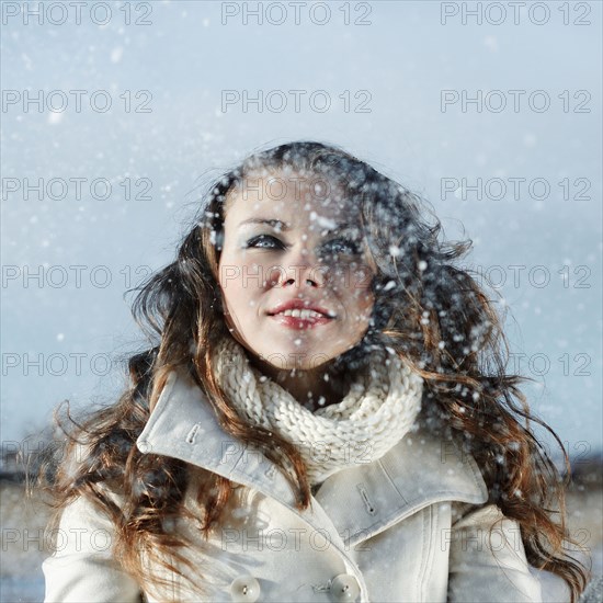 Caucasian woman playing in snow