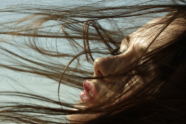 Caucasian woman with hair blowing in wind