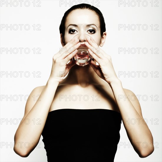 Caucasian woman drinking from glass