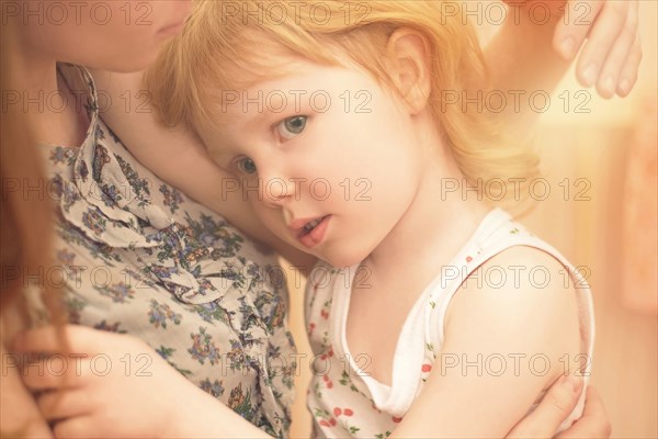 Caucasian mother hugging preschooler daughter