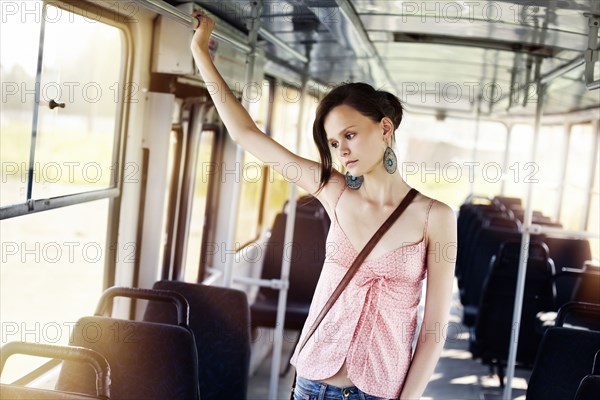 Caucasian woman riding bus