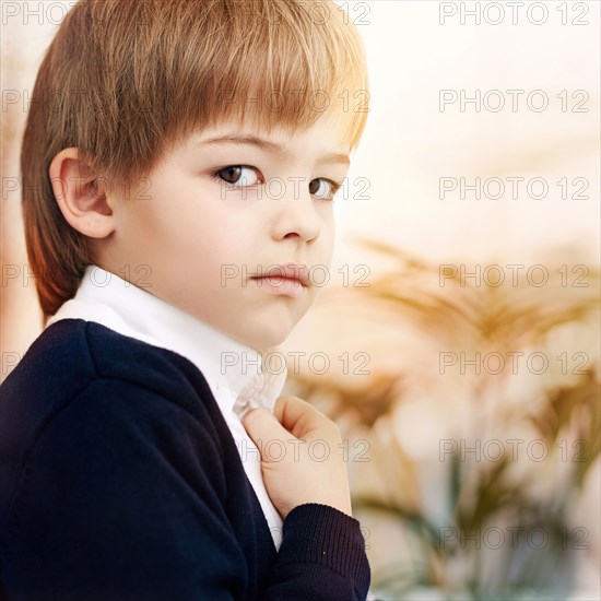 Close up of Caucasian boy wearing schoolboy uniform