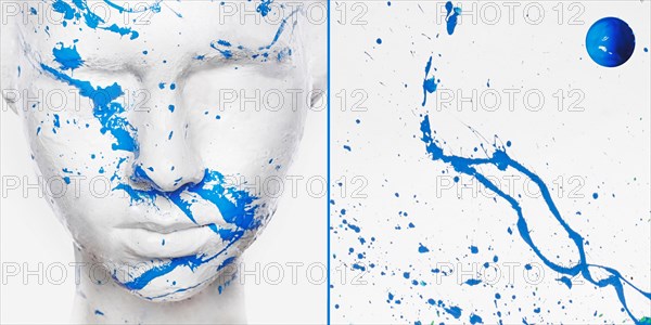 Caucasian woman in white makeup splashed with blue paint