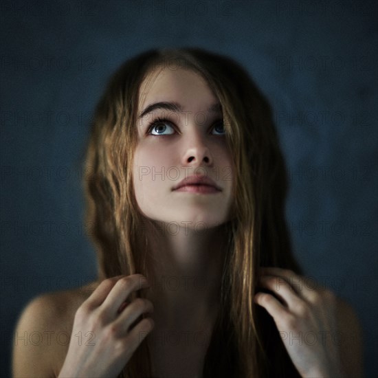 Caucasian teenage girl looking up