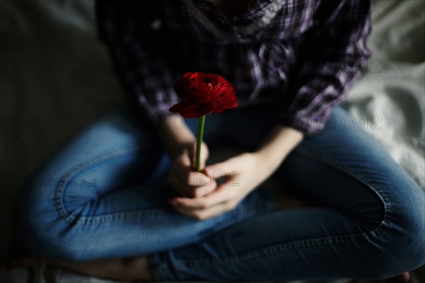 Caucasian teenage girl holding flower
