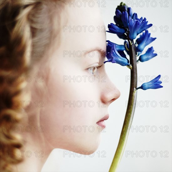 Caucasian teenage girl holding flower